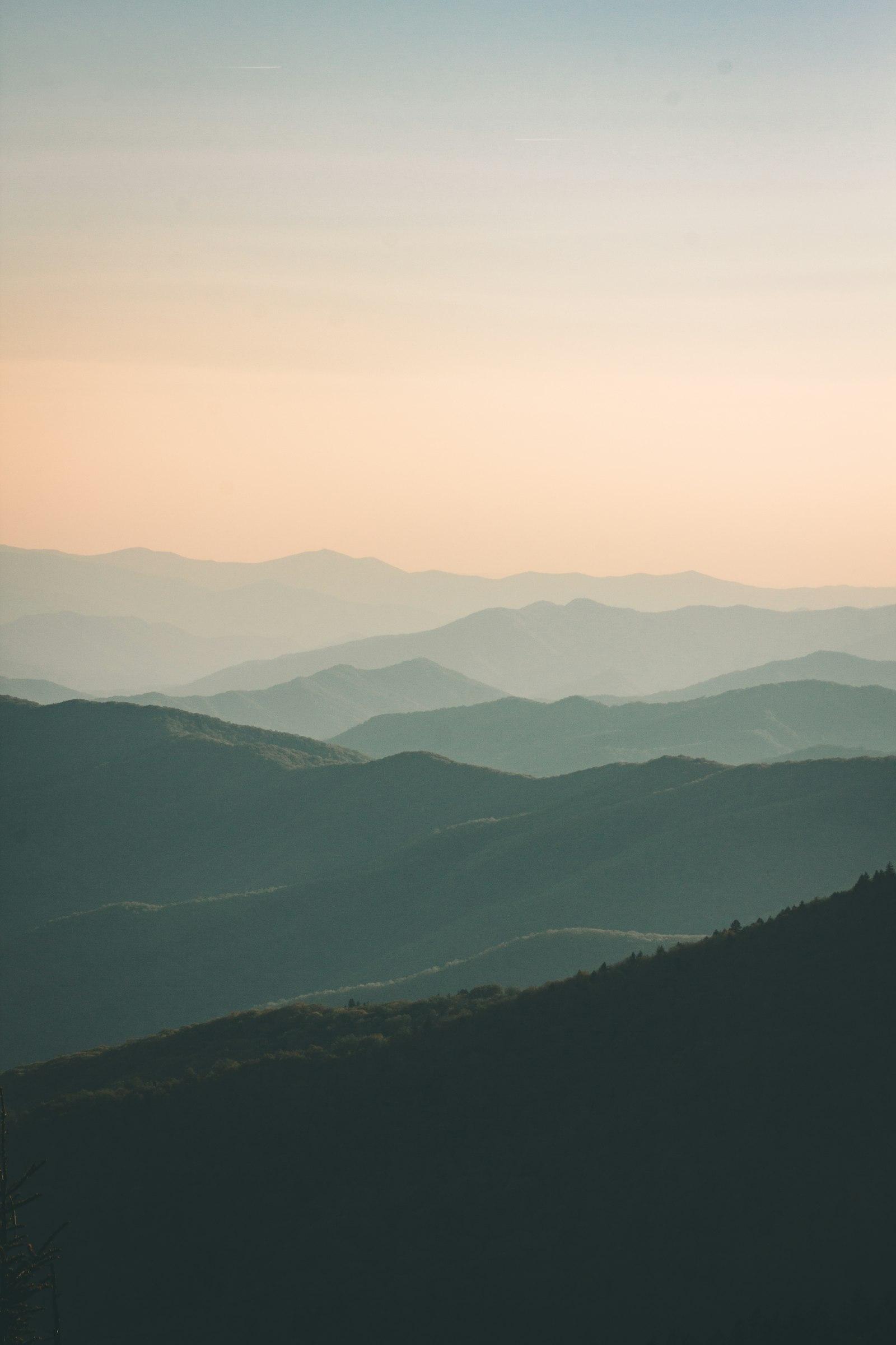 Layered mountain ridges at sunrise